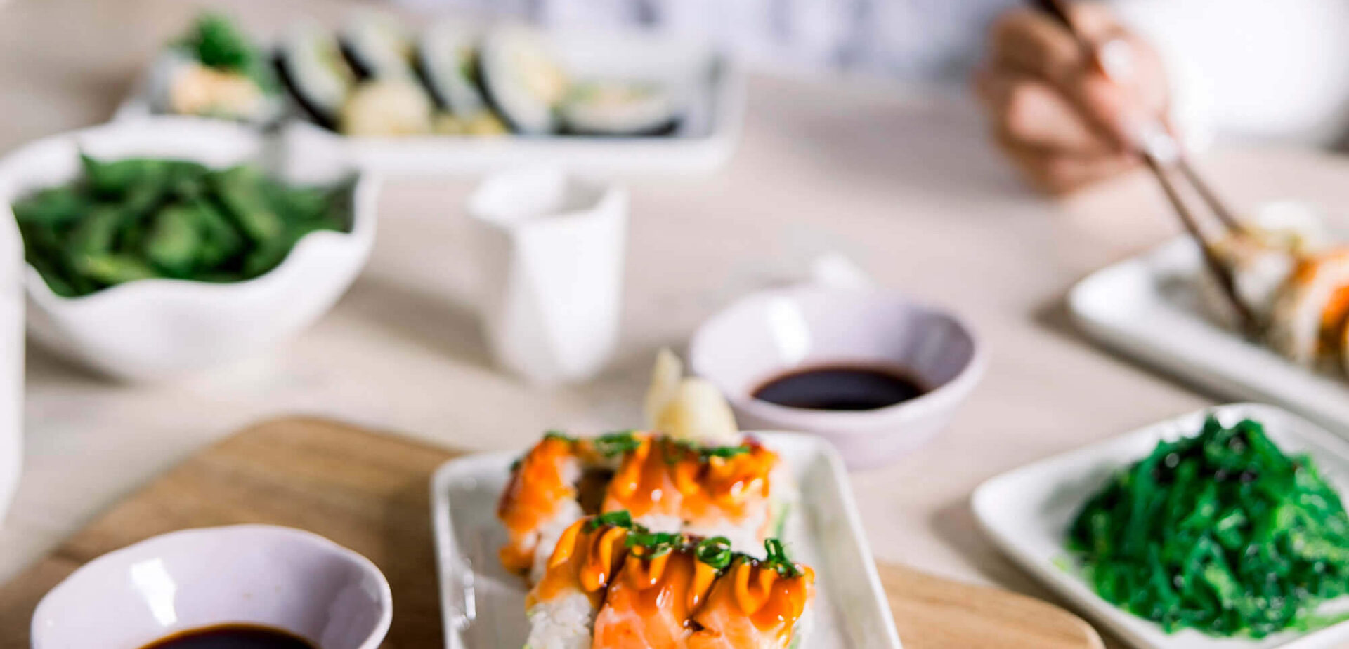 A table setting with sushi, soy sauce and more
